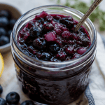 Blueberry chutney with a spoon for serving.